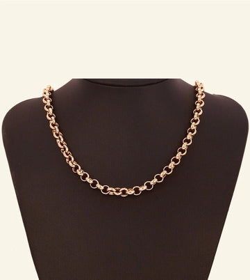 Rose gold chain necklace on a black mannequin bust against a beige background