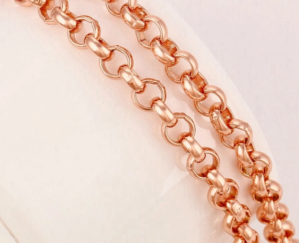 Rose gold chain on a light pink background