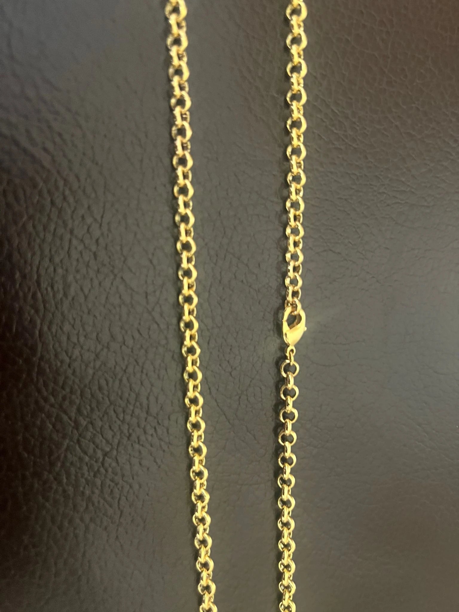 Gold chain on a dark textured background