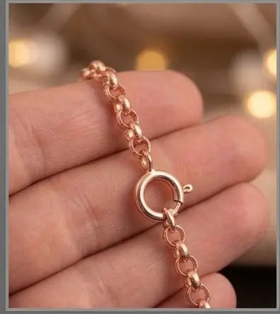 Rose gold necklace on a hand with a blurred background