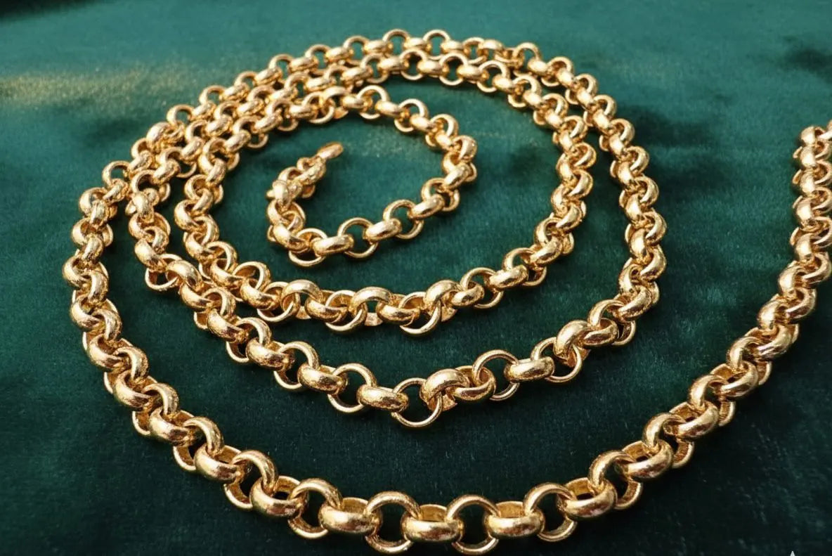 Gold chain on a green fabric background
