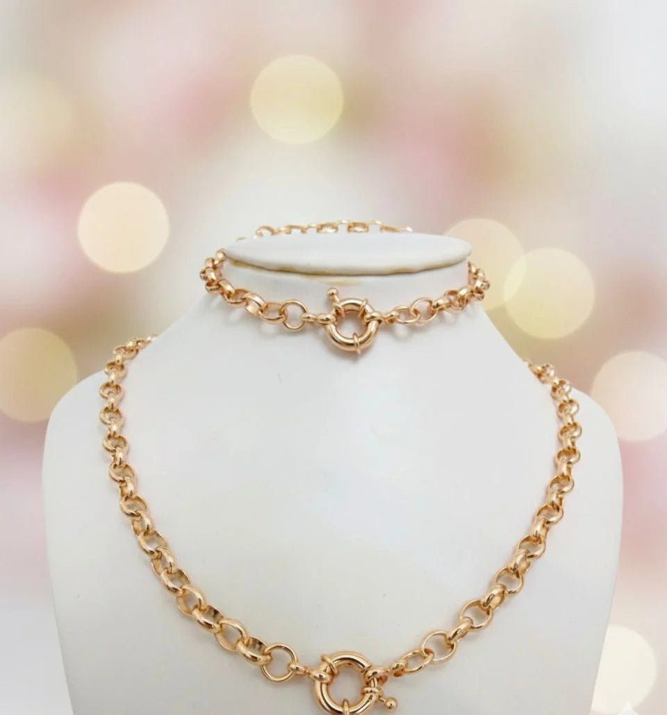 Gold chain necklace on a mannequin with a soft, blurred background