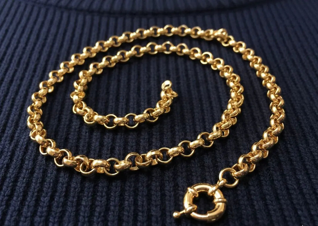 Gold chain necklace on a black and white background